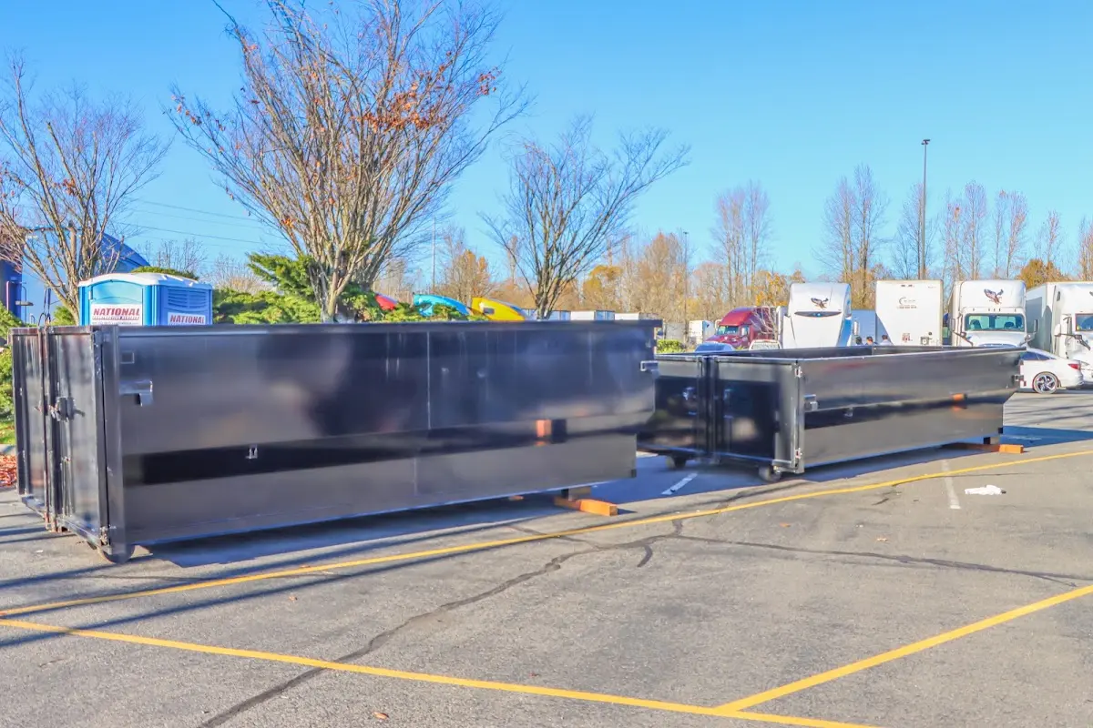 Professional dumpster rental service with roll-off container on residential driveway in Cypress